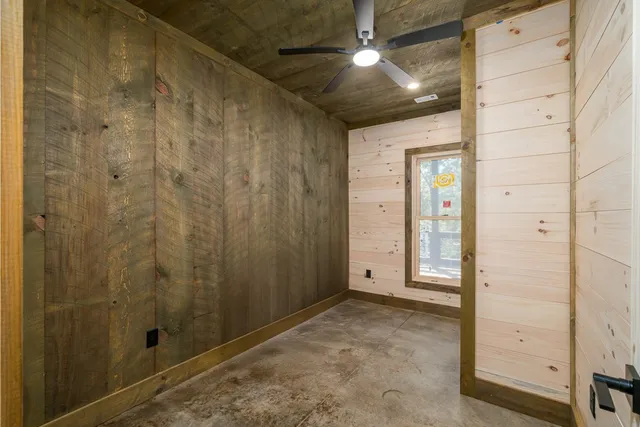 a view of a balcony with chairs and wooden floor