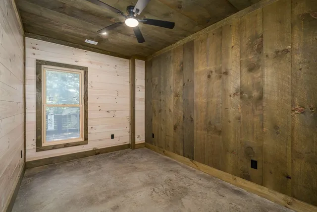 a view of a room with wooden floor and windows