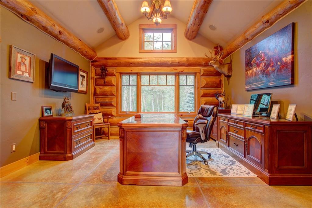 279 Two Cabins Drive Silverthorne, CO 80498 - Photo 12 of 30 a living room with furniture a flat screen tv and kitchen view
