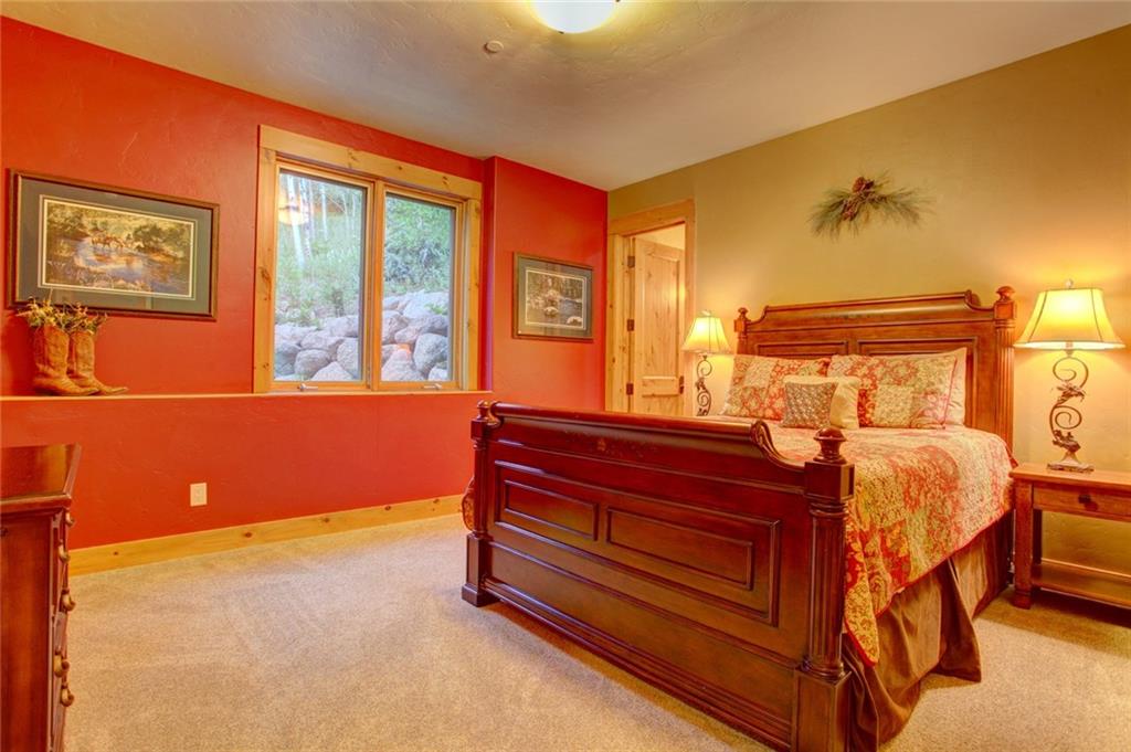 279 Two Cabins Drive Silverthorne, CO 80498 - Photo 15 of 30 a room with a bed and a dresser next to a window