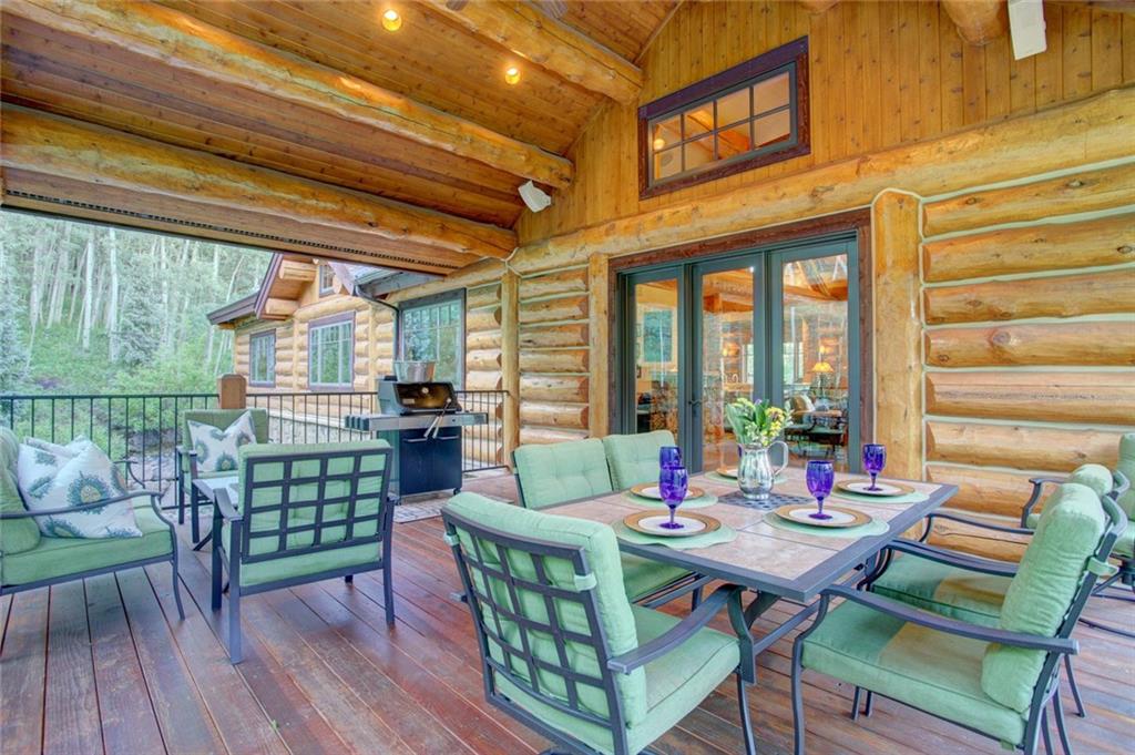 279 Two Cabins Drive Silverthorne, CO 80498 - Photo 23 of 30 a view of a dining table and chairs in back porch of a house
