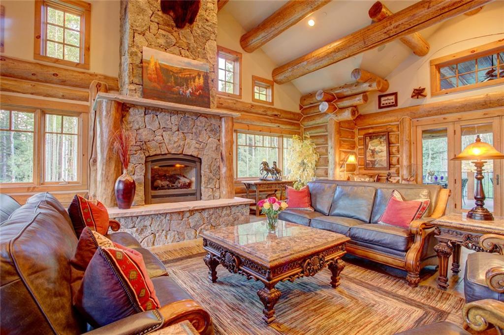 279 Two Cabins Drive Silverthorne, CO 80498 - Photo 25 of 30 a living room with furniture a fireplace and a large window