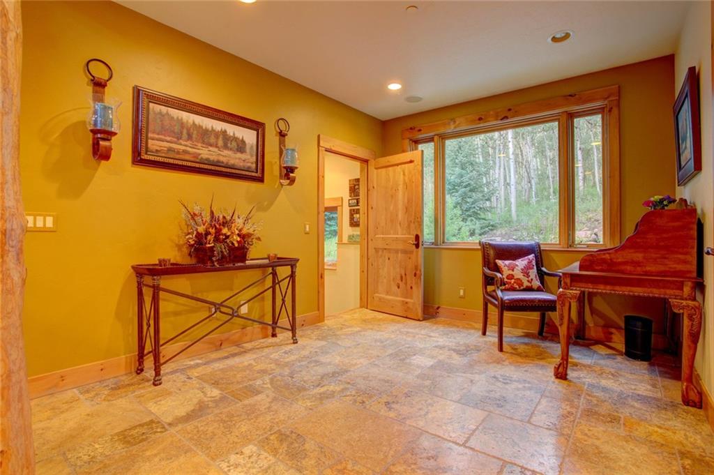 279 Two Cabins Drive Silverthorne, CO 80498 - Photo 27 of 30 a living room with furniture a window and a flat screen tv