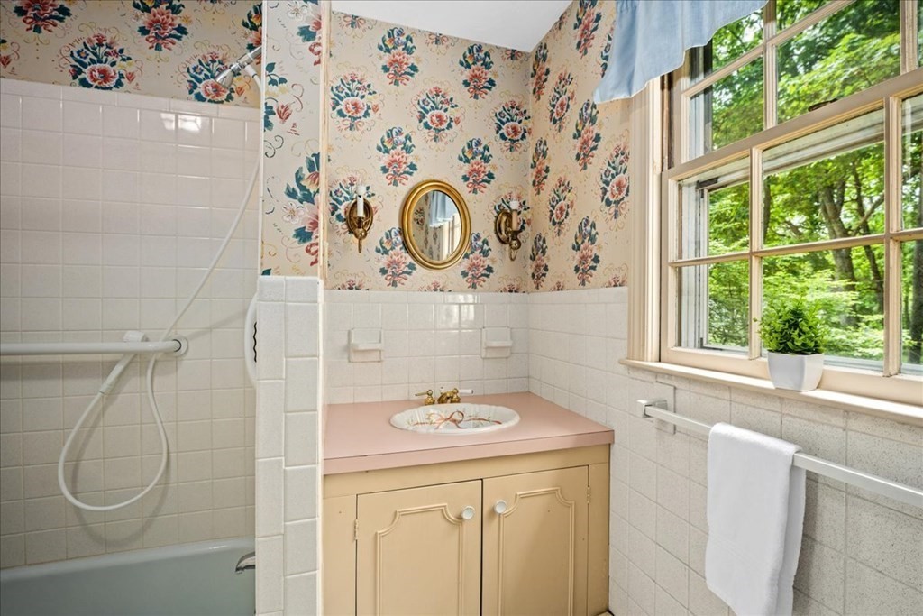 30 Cross Street Shrewsbury, MA 01545 - Photo 23 of 41 a bathroom with a granite countertop sink a mirror and a shower curtain