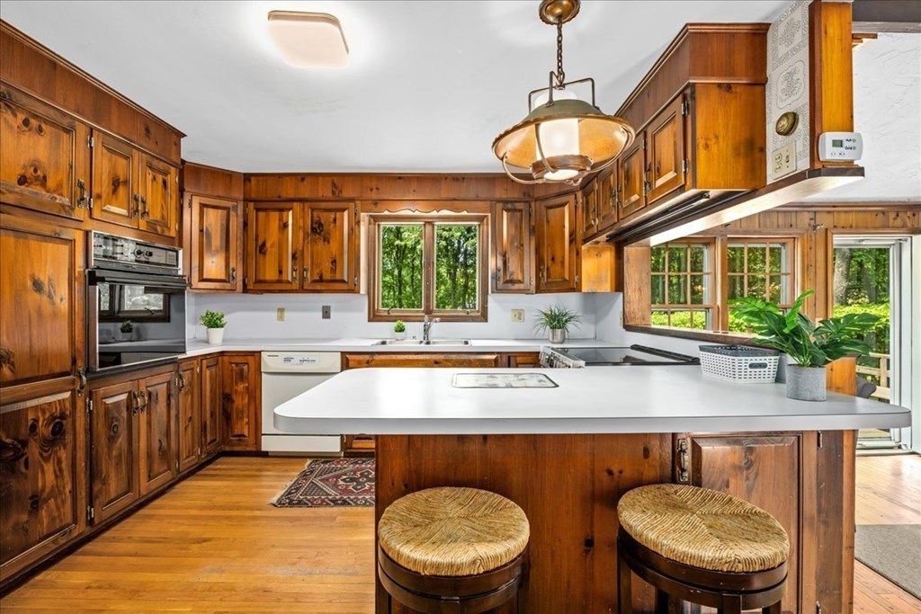 30 Cross Street Shrewsbury, MA 01545 - Photo 5 of 41 a kitchen with stainless steel appliances granite countertop a sink a stove and a wooden cabinets