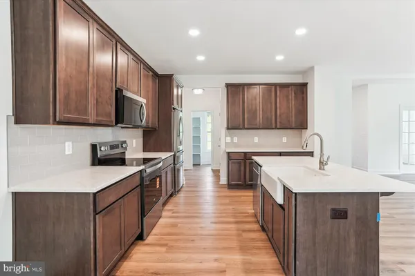 a view of a kitchen with a sink and a refrigerator