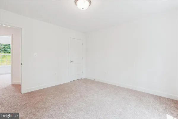 a view of a room with a ceiling fan and a window