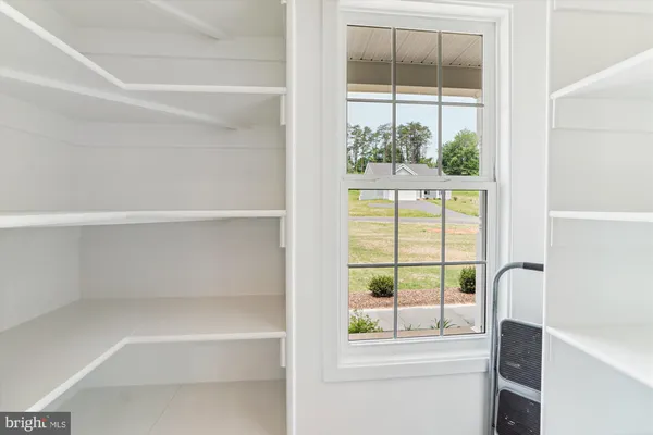 a large kitchen with stainless steel appliances kitchen island a large counter top and a wooden floors