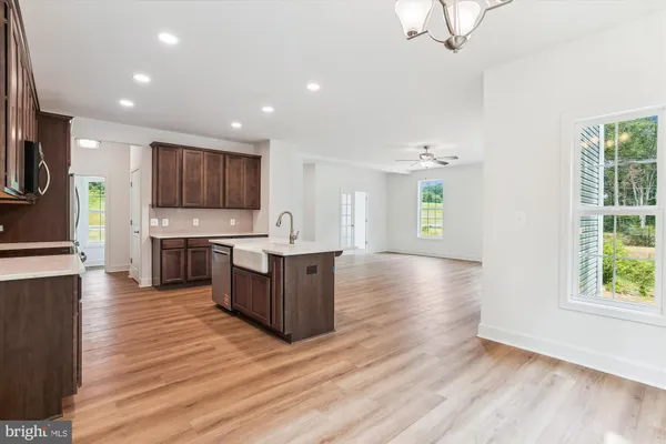 a view of an empty walk in closet with wooden floor