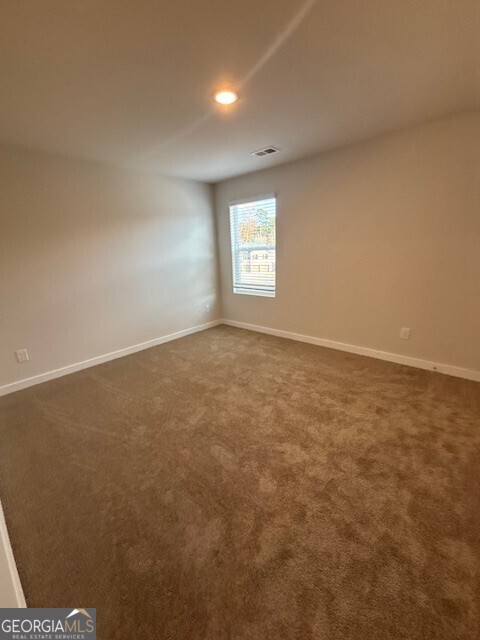 346 Jarrett Street, Unit 56 Fairburn, GA 30213 - Photo 11 of 25 an empty room with an entryway
