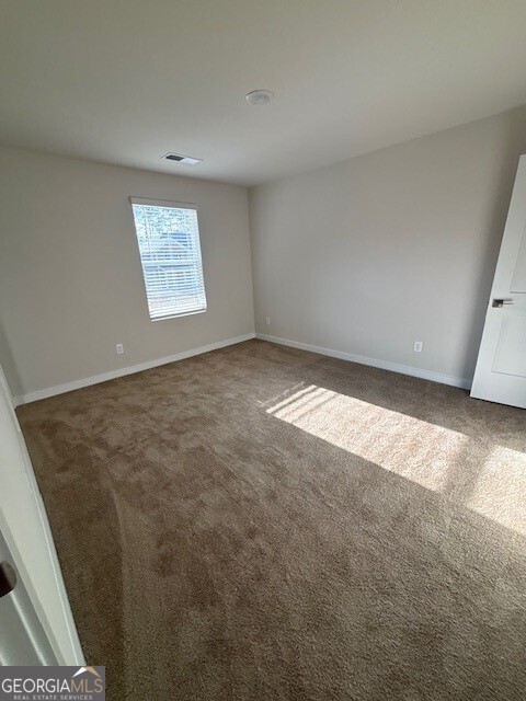 346 Jarrett Street, Unit 56 Fairburn, GA 30213 - Photo 12 of 25 an empty room with windows