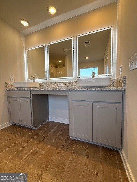 346 Jarrett Street, Unit 56 Fairburn, GA 30213 - Photo 14 of 25 a bathroom with a sink and a mirror