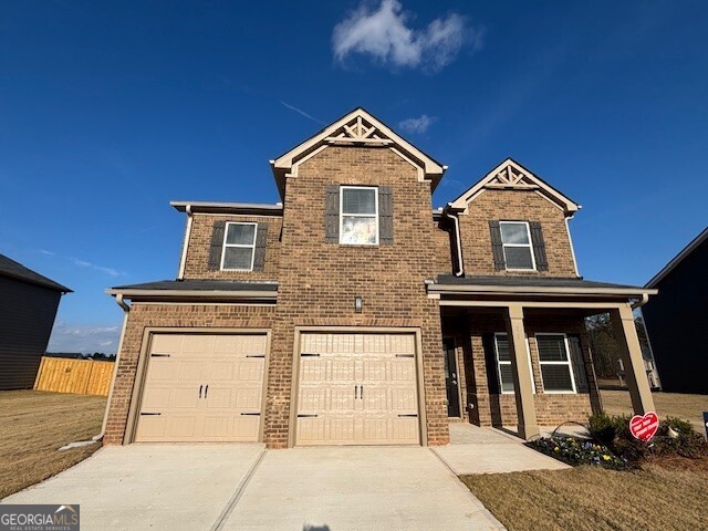 346 Jarrett Street, Unit 56 Fairburn, GA 30213 - Photo 2 of 25 a view of a brick house with large windows
