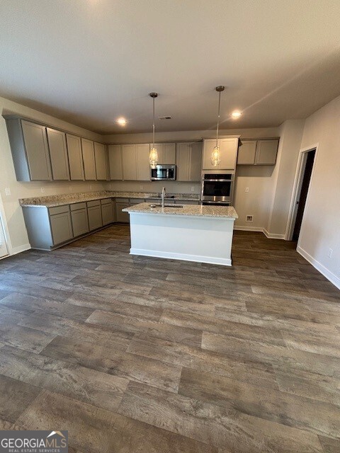 346 Jarrett Street, Unit 56 Fairburn, GA 30213 - Photo 5 of 25 a view of kitchen with kitchen island a sink stainless steel appliances and cabinets