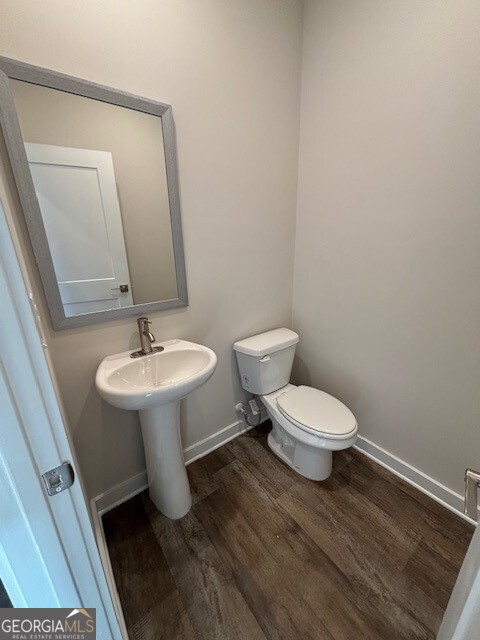 346 Jarrett Street, Unit 56 Fairburn, GA 30213 - Photo 7 of 25 a bathroom with a toilet sink and mirror