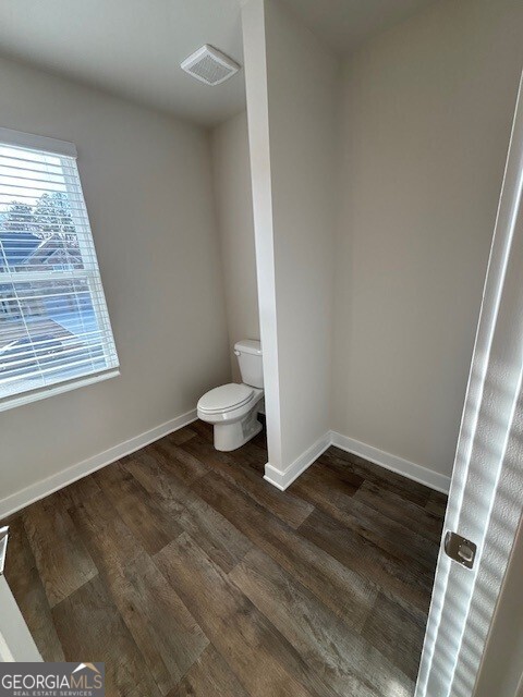 346 Jarrett Street, Unit 56 Fairburn, GA 30213 - Photo 8 of 25 a view of an empty room and wooden floor and a window
