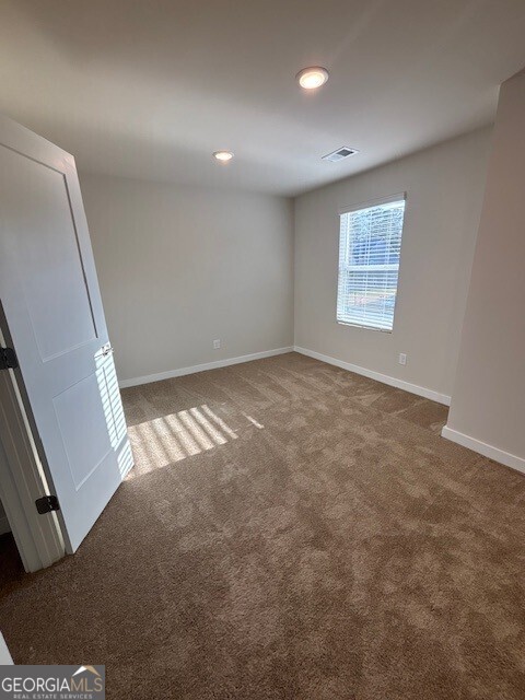 346 Jarrett Street, Unit 56 Fairburn, GA 30213 - Photo 10 of 25 an empty room with windows