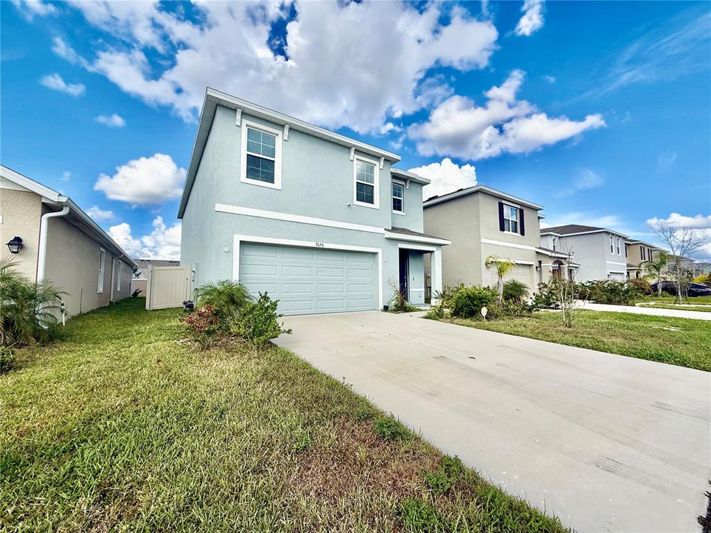 a front view of a house with a yard and garage