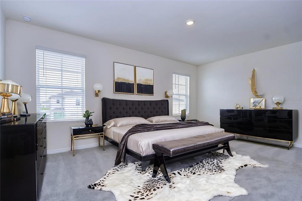 9176 Forge Breeze Loop Wesley Chapel, FL 33545 - Photo 11 of 33 a bedroom with a bed and dresser