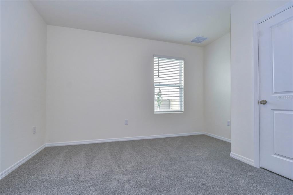 9176 Forge Breeze Loop Wesley Chapel, FL 33545 - Photo 15 of 33 an empty room with a window