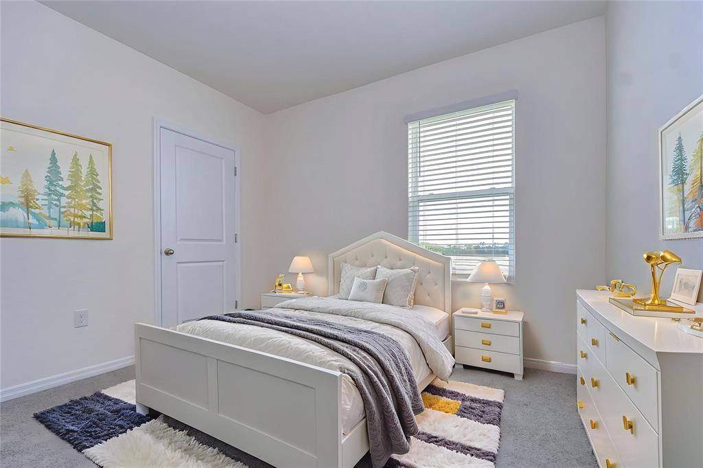 9176 Forge Breeze Loop Wesley Chapel, FL 33545 - Photo 18 of 33 a bedroom with a bed and a window