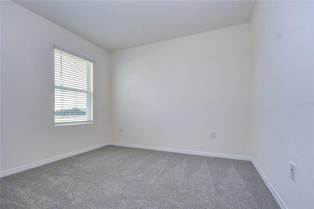 9176 Forge Breeze Loop Wesley Chapel, FL 33545 - Photo 19 of 33 an empty room with a window
