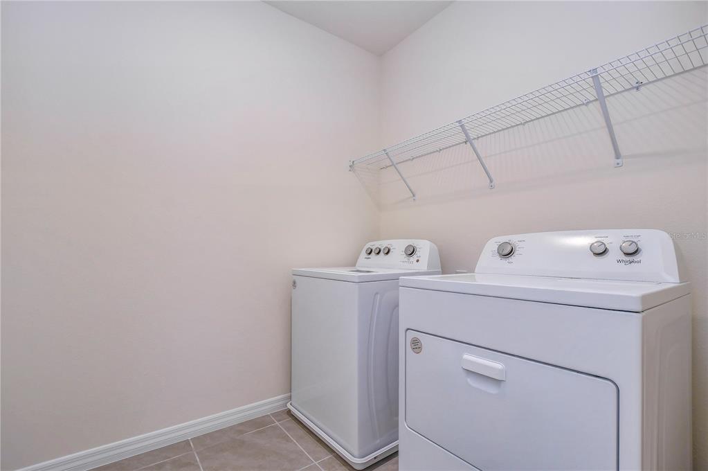 9176 Forge Breeze Loop Wesley Chapel, FL 33545 - Photo 21 of 33 a utility room with dryer and washer