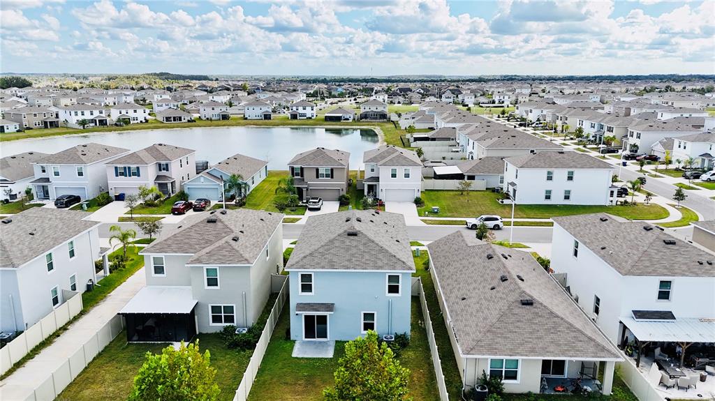 9176 Forge Breeze Loop Wesley Chapel, FL 33545 - Photo 25 of 33 an aerial view of residential houses with outdoor space and ocean view