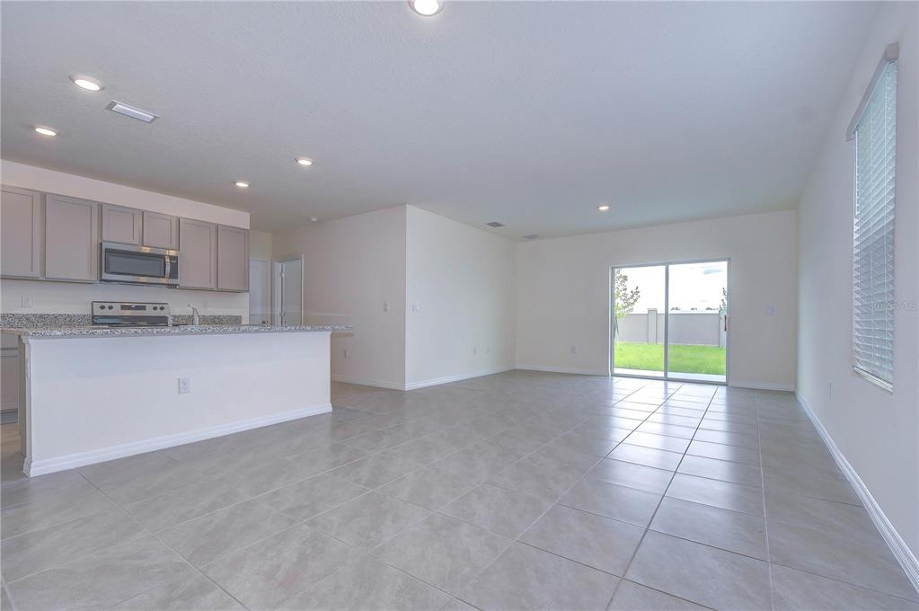 9176 Forge Breeze Loop Wesley Chapel, FL 33545 - Photo 5 of 33 a view of a kitchen with a sink and a window