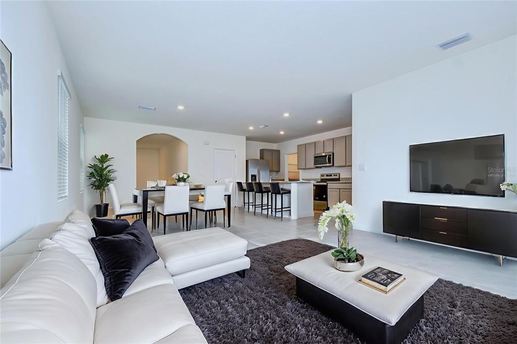 9176 Forge Breeze Loop Wesley Chapel, FL 33545 - Photo 6 of 33 a living room with furniture and a flat screen tv