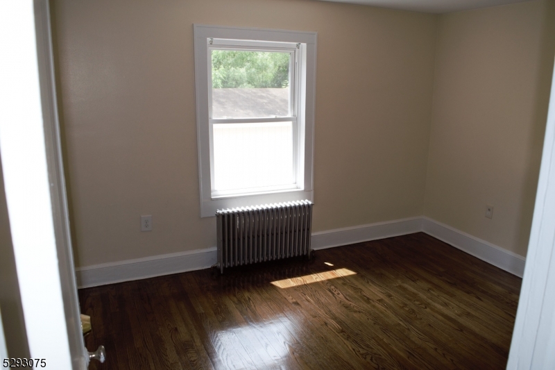 55 Highway 23, Unit 1 Hamburg, NJ 07419 - Photo 13 of 14 an empty room with wooden floor and windows