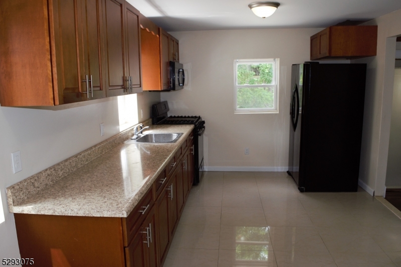 55 Highway 23, Unit 1 Hamburg, NJ 07419 - Photo 2 of 14 a kitchen with stainless steel appliances granite countertop a refrigerator a stove and a microwave