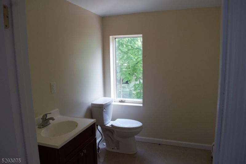 55 Highway 23, Unit 1 Hamburg, NJ 07419 - Photo 5 of 14 a bathroom with a sink toilet a mirror and window