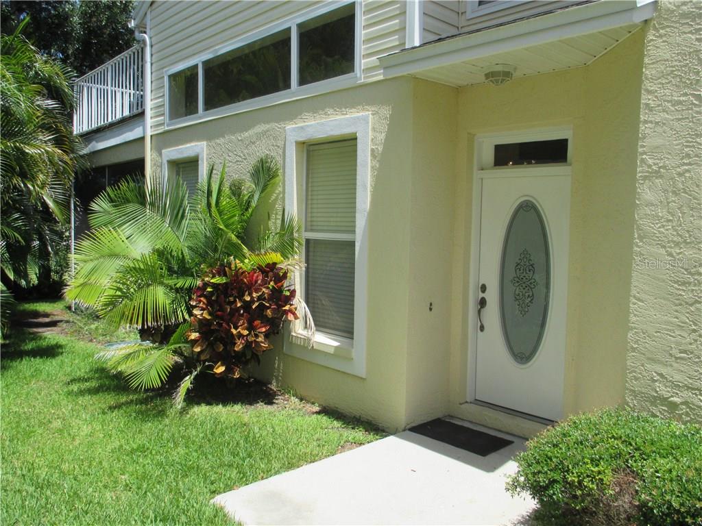1050 Starkey Road, Unit 2601 Largo, FL 33771 - Photo 1 of 1 Entrance to townhome. Note transom window in living room. Balcony off the upstairs master bedroom can be seen. The balcony is over the screened patio. Each can view the 11th fairway!