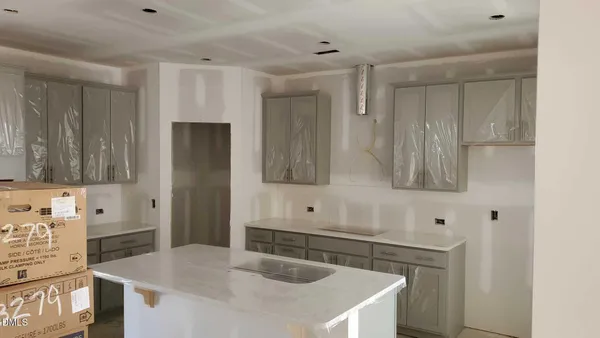 a kitchen with stainless steel appliances granite countertop a sink and a refrigerator