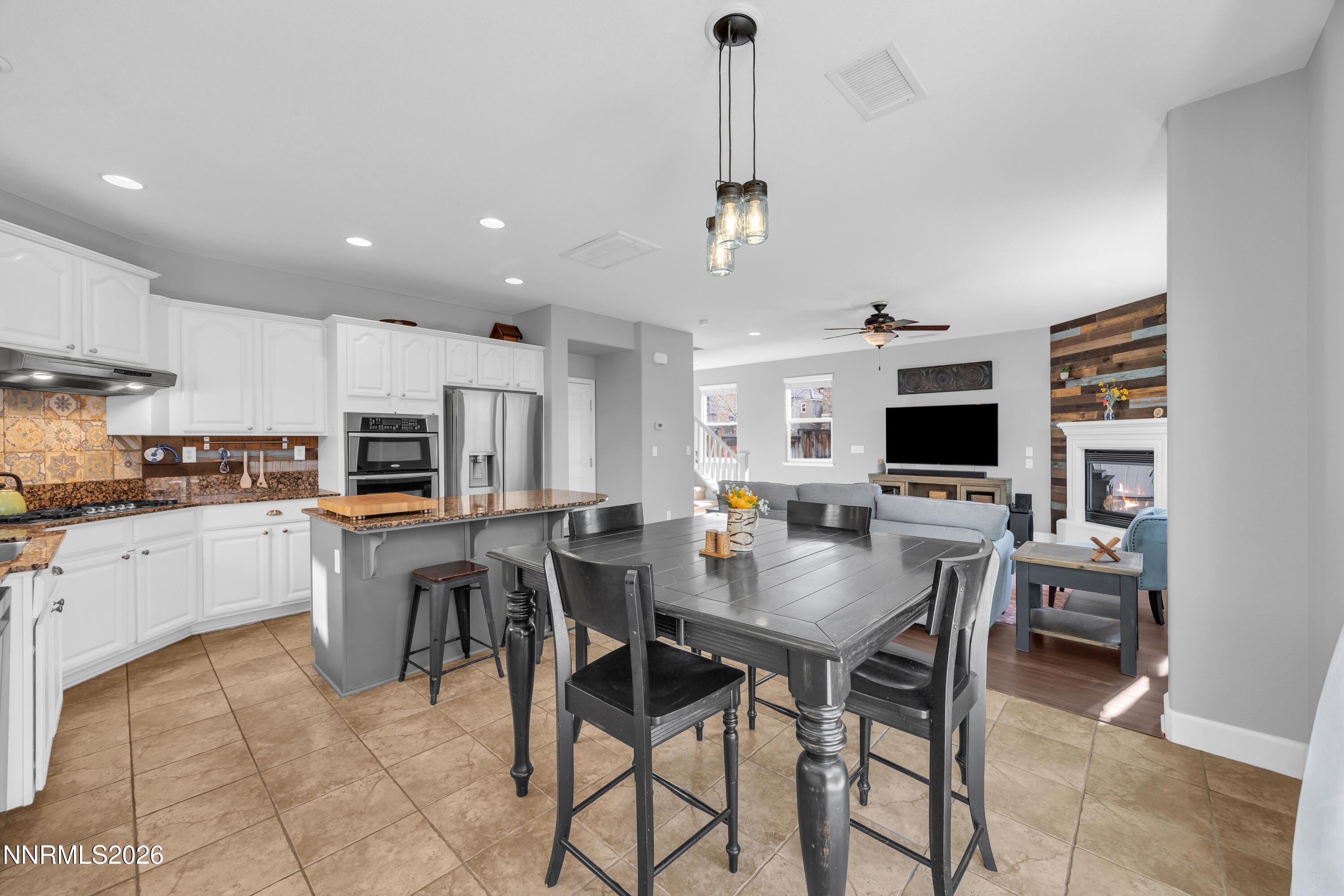 2085 Black Sand Drive Reno, NV 89521 - Photo 11 of 37 a view of kitchen with refrigerator stove dining table and chairs