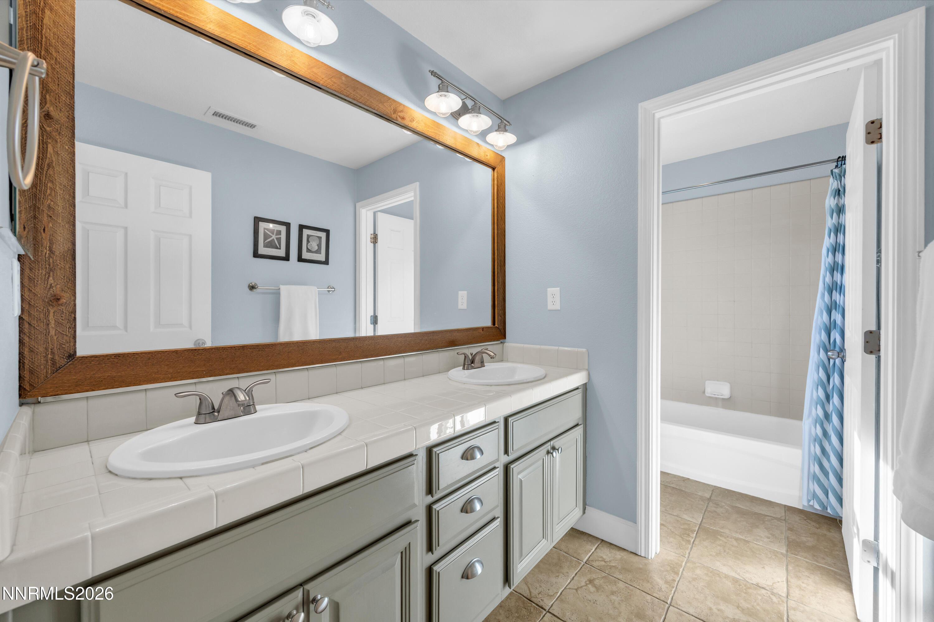 2085 Black Sand Drive Reno, NV 89521 - Photo 22 of 37 a bathroom with a granite countertop sink and a mirror
