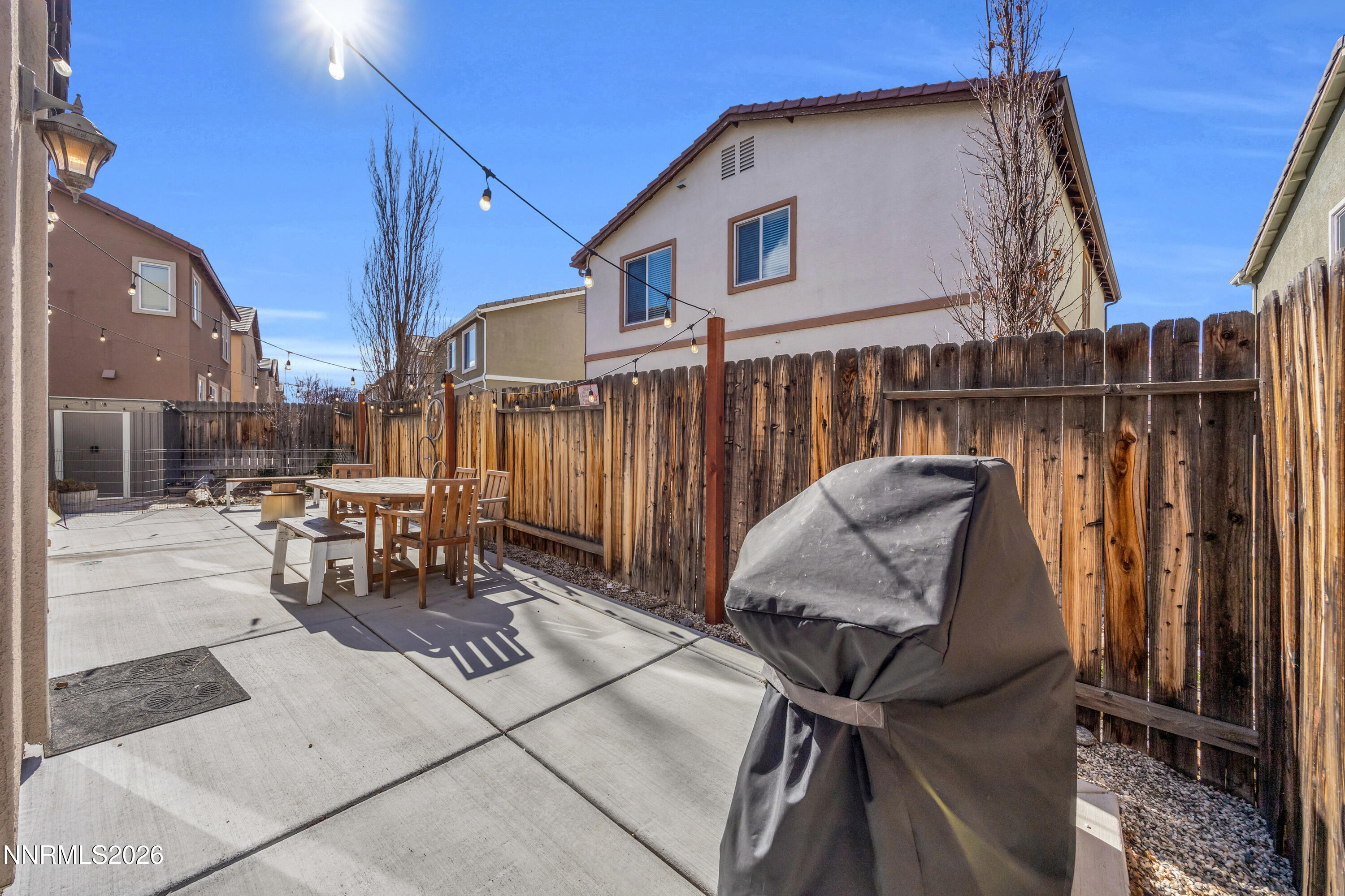 2085 Black Sand Drive Reno, NV 89521 - Photo 27 of 37 a view of a patio with table and chairs with wooden floor and fence