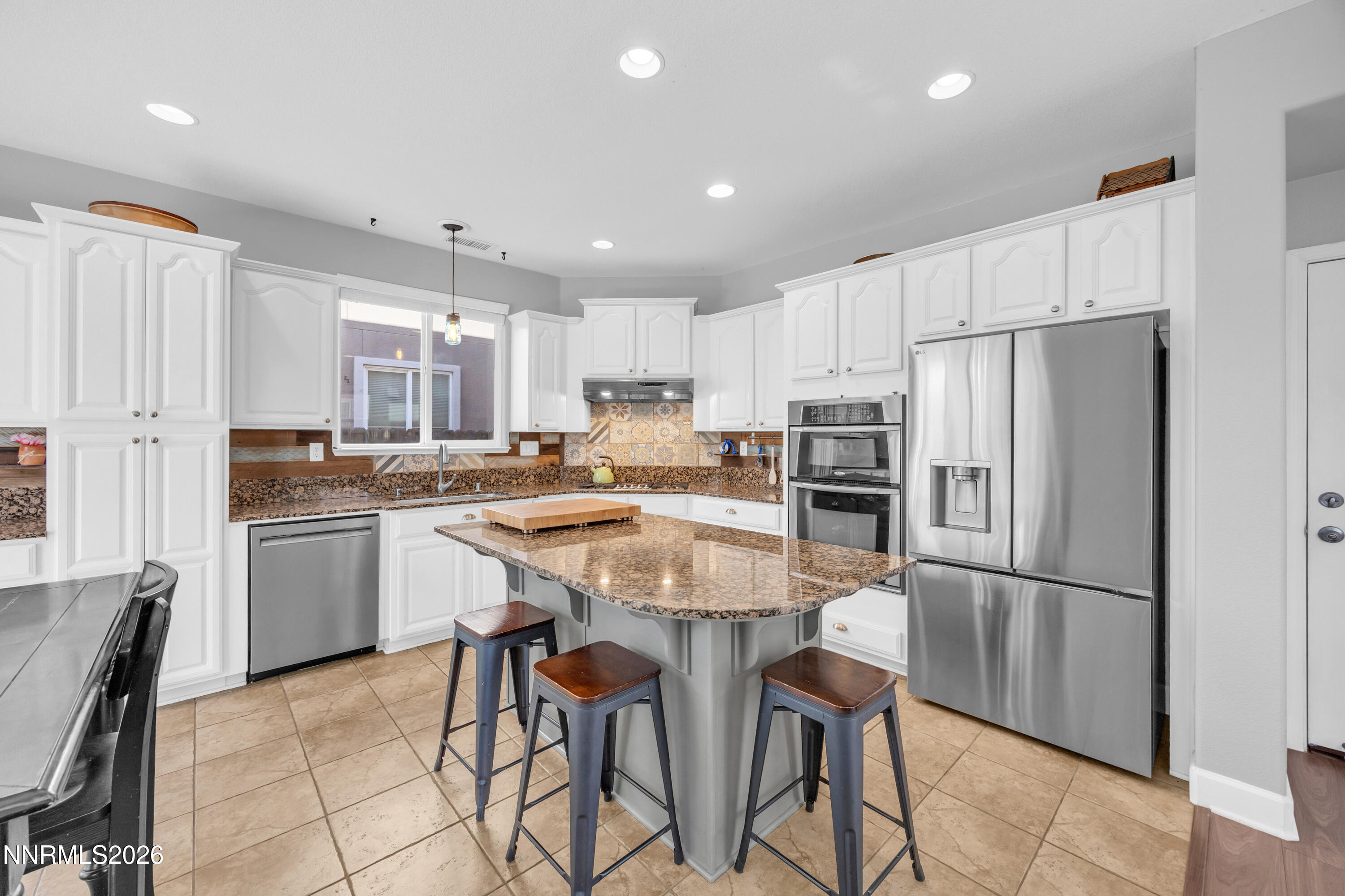 2085 Black Sand Drive Reno, NV 89521 - Photo 6 of 37 a kitchen with stainless steel appliances a refrigerator stove microwave and cabinets