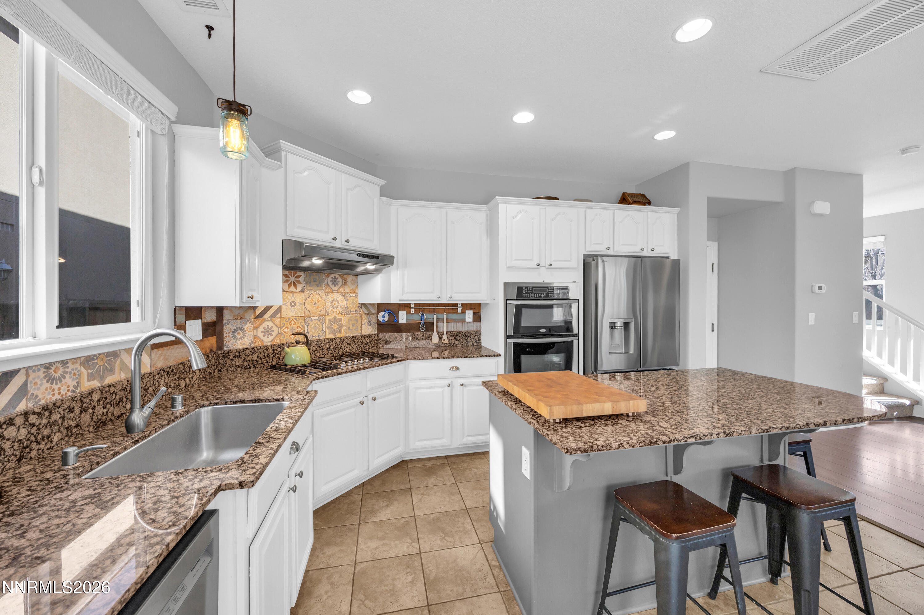 2085 Black Sand Drive Reno, NV 89521 - Photo 7 of 37 a large kitchen with granite countertop a sink counter space stainless steel appliances and cabinets