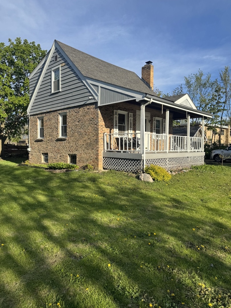 197 6th Street Wheeling, IL 60090 - Photo 1 of 51 a front view of a house with a yard table and chairs