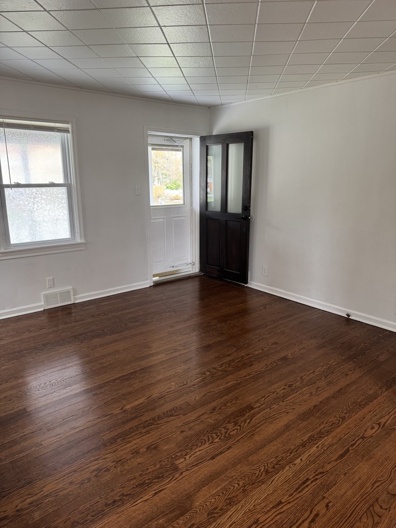 197 6th Street Wheeling, IL 60090 - Photo 44 of 51 a view of an empty room with wooden floor and a window