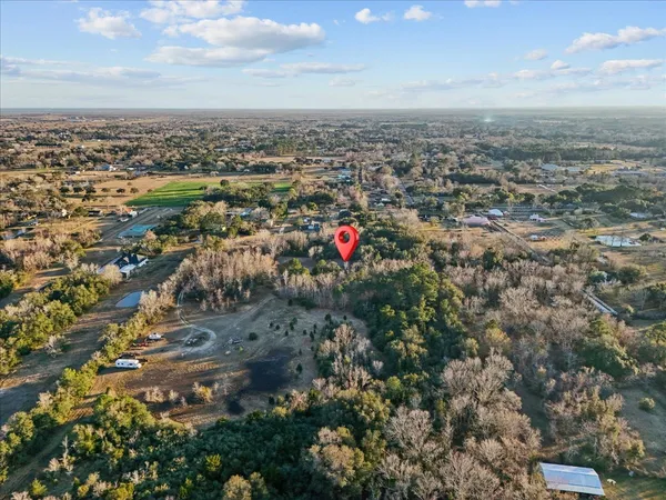 an aerial view of a houses with a yard