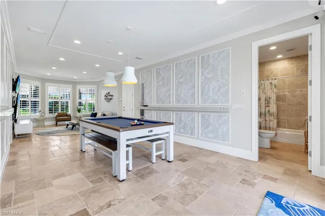 a living room with furniture a flat screen tv and a floor to ceiling window