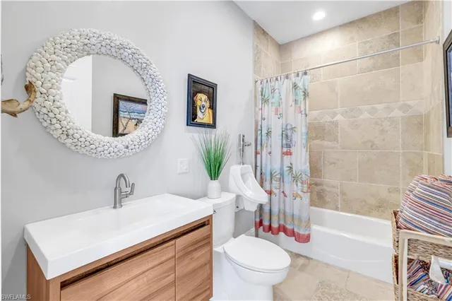 a living room with stainless steel appliances furniture a rug and a view of kitchen