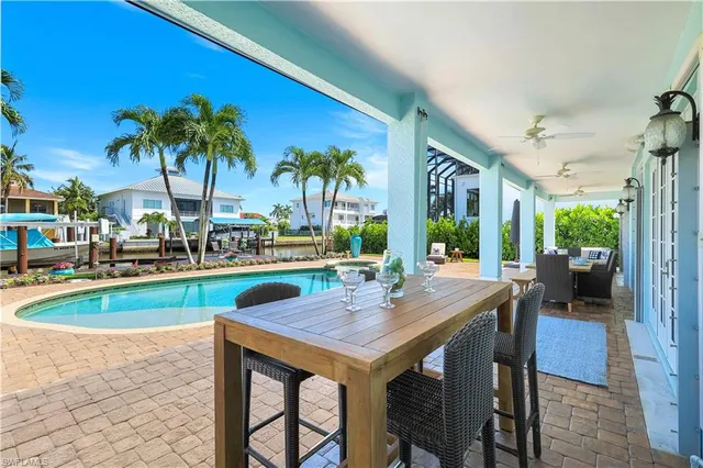 a view of a dining room with furniture a chandelier and wooden floor