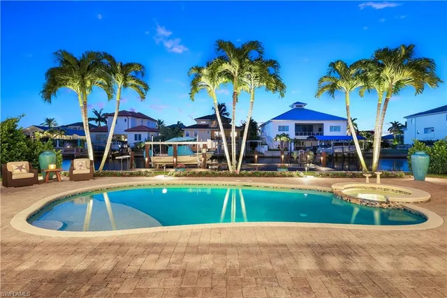 a swimming pool with outdoor seating and yard