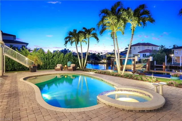 a view of a swimming pool with chairs