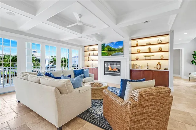 a living room with fireplace furniture and a large window