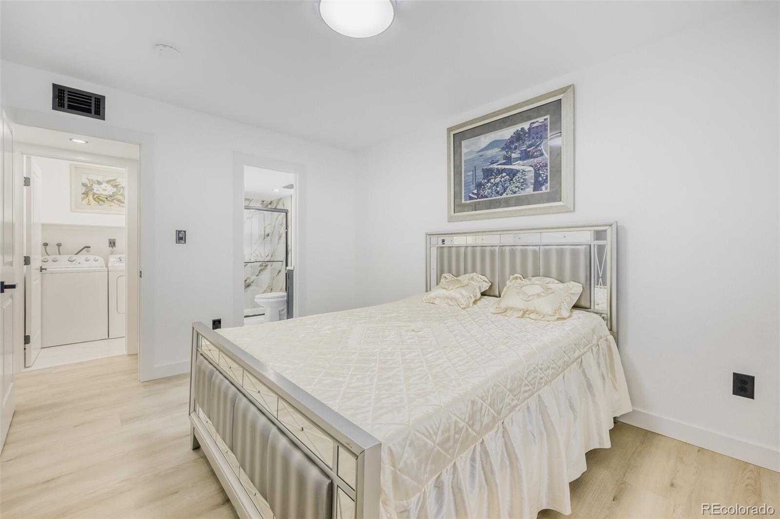 4400 South Quebec Street, Unit 106W Denver, CO 80237 - Photo 14 of 17 a bedroom with a bed and a flat screen tv